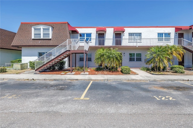 9105 W Hillsborough Ave Unit I102, Tampa, FL 33615 - view of building exterior with uncovered parking