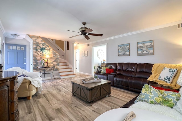 8326 Archwood Cir, Tampa, FL 33615 - living room with crown molding, stairs, baseboards, ceiling fan, and light wood-style flooring