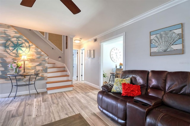 8326 Archwood Cir, Tampa, FL 33615 - living room with stairs, crown molding, wood finished floors, baseboards, and ceiling fan