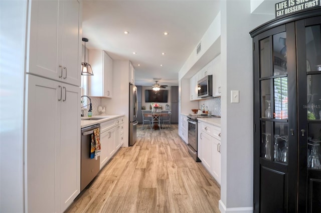 8326 Archwood Cir, Tampa, FL 33615 - kitchen with visible vents, white cabinets, a sink, and stainless steel appliances
