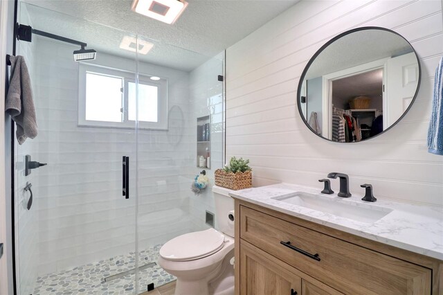 8326 Archwood Cir, Tampa, FL 33615 - full bathroom with a textured ceiling, toilet, a stall shower, and vanity