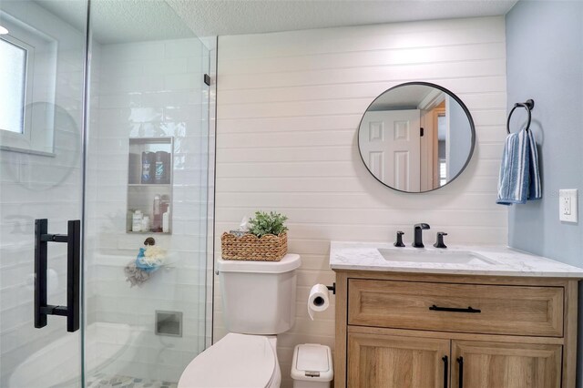 8326 Archwood Cir, Tampa, FL 33615 - bathroom featuring a stall shower, toilet, vanity, and a textured ceiling