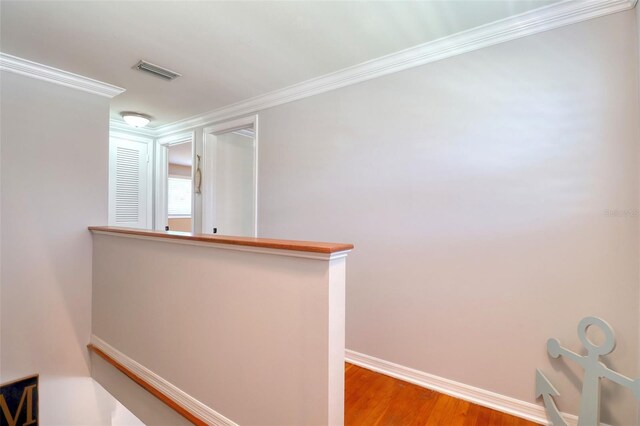 8326 Archwood Cir, Tampa, FL 33615 - corridor featuring an upstairs landing, light wood-type flooring, ornamental molding, baseboards, and visible vents