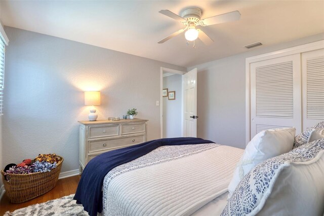 8326 Archwood Cir, Tampa, FL 33615 - bedroom featuring a ceiling fan, visible vents, a closet, and wood finished floors