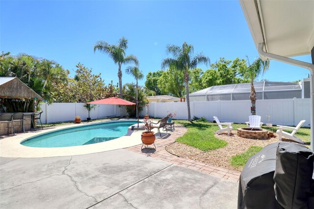 8326 Archwood Cir, Tampa, FL 33615 - view of pool with a patio, a fenced backyard, grilling area, a fenced in pool, and a fire pit
