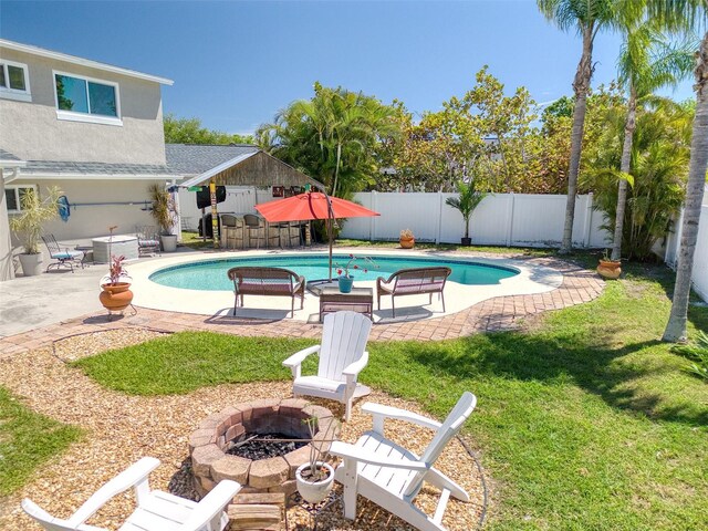 8326 Archwood Cir, Tampa, FL 33615 - view of swimming pool featuring a fire pit, a patio area, a fenced in pool, a fenced backyard, and a lawn