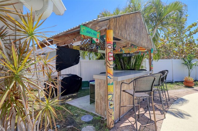 8326 Archwood Cir, Tampa, FL 33615 - view of patio / terrace with outdoor dry bar and fence