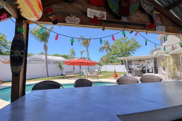 8326 Archwood Cir, Tampa, FL 33615 - view of patio / terrace with a sunroom, a fenced in pool, and a fenced backyard