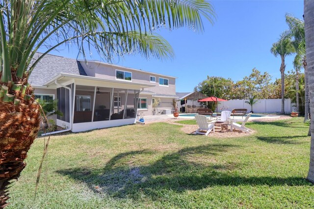 8326 Archwood Cir, Tampa, FL 33615 - rear view of property featuring a fenced in pool, stucco siding, a fenced backyard, a sunroom, and a lawn