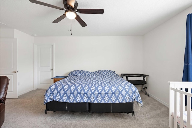 carpeted bedroom with a ceiling fan and baseboards