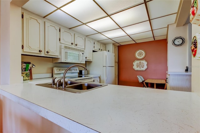 14130 Rosemary Ln Unit 3312, Largo, FL 33774 - kitchen with a drop ceiling, light countertops, a sink, and white appliances