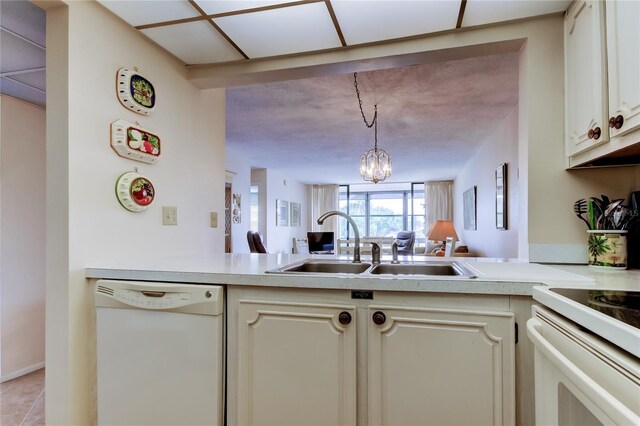 14130 Rosemary Ln Unit 3312, Largo, FL 33774 - kitchen with light countertops, an inviting chandelier, a peninsula, and white appliances
