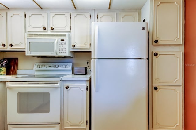 14130 Rosemary Ln Unit 3312, Largo, FL 33774 - kitchen featuring white cabinetry, light countertops, and white appliances