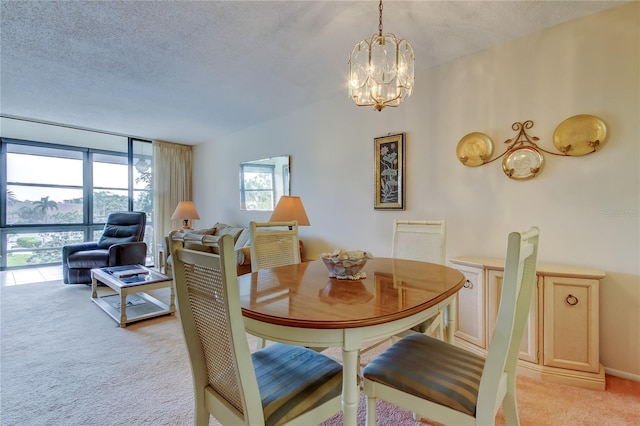 14130 Rosemary Ln Unit 3312, Largo, FL 33774 - dining space featuring a textured ceiling, a chandelier, and light carpet