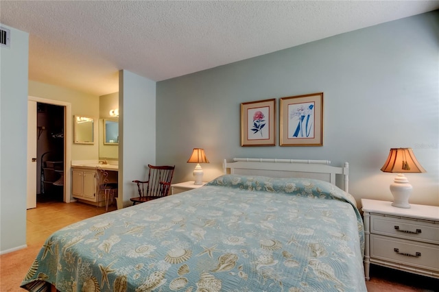 14130 Rosemary Ln Unit 3312, Largo, FL 33774 - bedroom featuring connected bathroom, light colored carpet, visible vents, and a textured ceiling