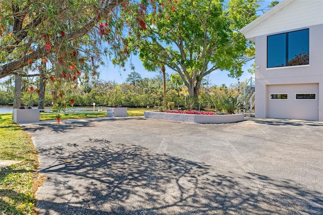 7049 Peninsular Dr, New Port Richey, FL 34652 - view of community featuring a garage and stairs