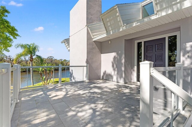 7049 Peninsular Dr, New Port Richey, FL 34652 - view of patio with a water view and a balcony
