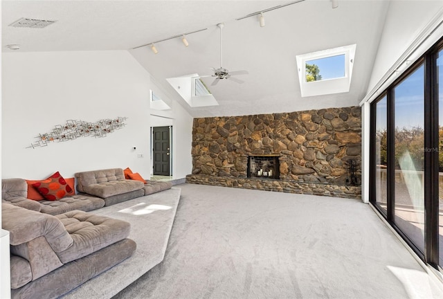 7049 Peninsular Dr, New Port Richey, FL 34652 - living area featuring track lighting, a skylight, carpet flooring, ceiling fan, and high vaulted ceiling