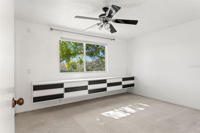7049 Peninsular Dr, New Port Richey, FL 34652 - carpeted spare room featuring ceiling fan, a textured ceiling, and baseboards