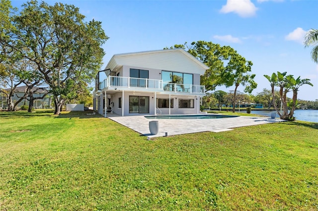 7049 Peninsular Dr, New Port Richey, FL 34652 - back of property with a balcony, a patio area, an outdoor pool, a water view, and a lawn