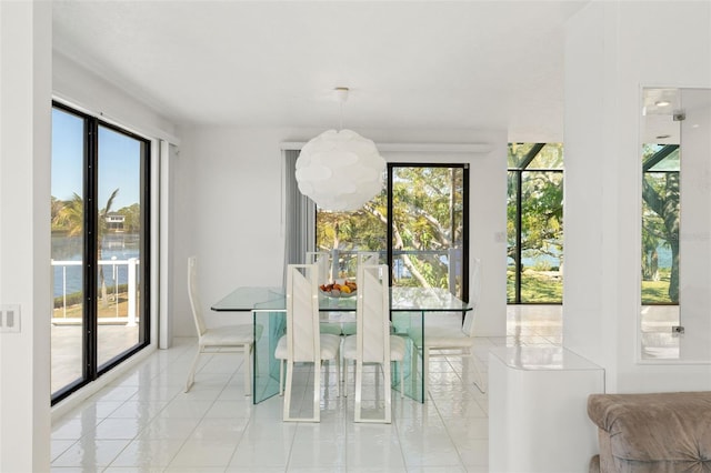 7049 Peninsular Dr, New Port Richey, FL 34652 - dining space featuring plenty of natural light, tile patterned flooring, a chandelier, and french doors