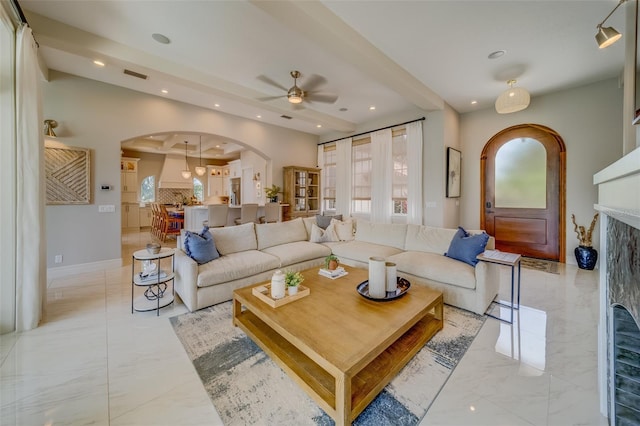 362 41st Ave, St Pete Beach, FL 33706 - living room featuring arched walkways, marble finish floor, a fireplace, and a ceiling fan
