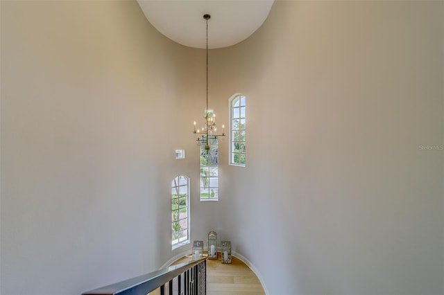 362 41st Ave, St Pete Beach, FL 33706 - interior space featuring baseboards, a high ceiling, wood finished floors, and an inviting chandelier