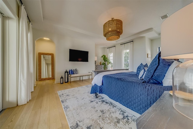 362 41st Ave, St Pete Beach, FL 33706 - bedroom with arched walkways, visible vents, and light wood finished floors