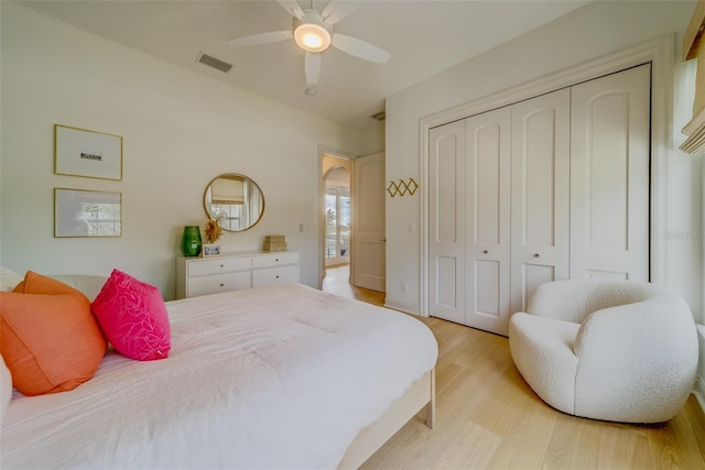 362 41st Ave, St Pete Beach, FL 33706 - bedroom with a closet, a ceiling fan, light wood-type flooring, visible vents, and arched walkways