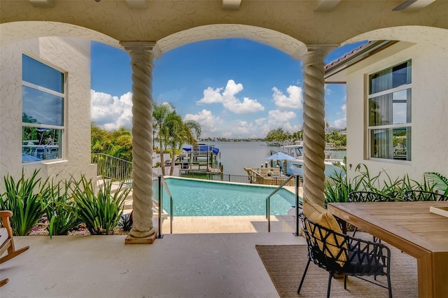 362 41st Ave, St Pete Beach, FL 33706 - view of pool with outdoor dining space, a water view, a patio, and a fenced in pool