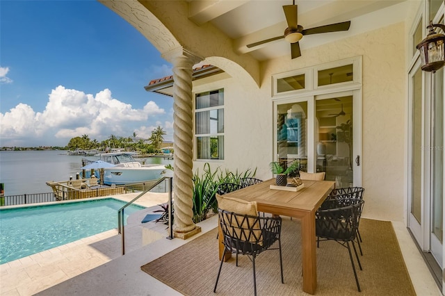 362 41st Ave, St Pete Beach, FL 33706 - exterior space featuring a water view, outdoor dining space, a fenced in pool, ceiling fan, and a boat dock