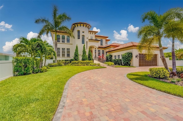 362 41st Ave, St Pete Beach, FL 33706 - mediterranean / spanish home with fence, a tiled roof, an attached garage, a front yard, and stucco siding