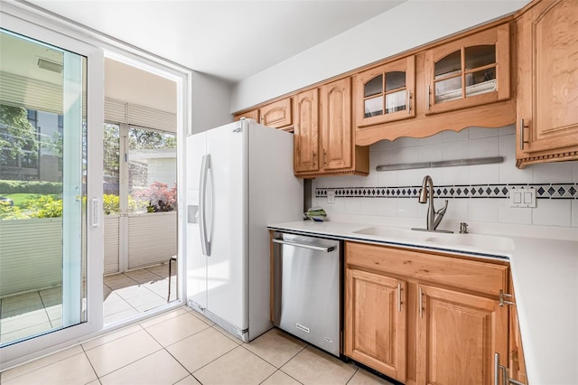 615 10th Ave NE Unit 1, Saint Petersburg, FL 33701 - kitchen featuring light countertops, tasteful backsplash, stainless steel dishwasher, a sink, and white fridge with ice dispenser