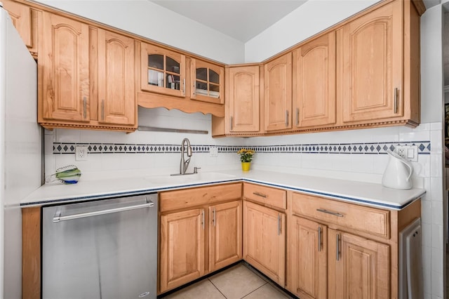 615 10th Ave NE Unit 1, Saint Petersburg, FL 33701 - kitchen featuring light countertops, glass insert cabinets, a sink, stainless steel dishwasher, and light tile patterned floors
