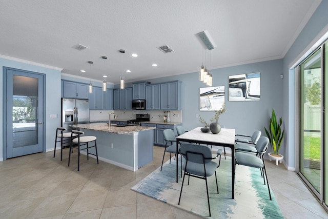 kitchen with visible vents, a healthy amount of sunlight, stainless steel appliances, and a sink