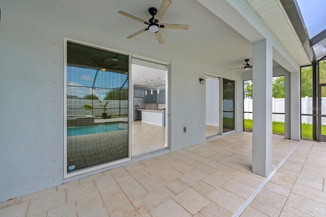 view of patio featuring fence and a ceiling fan