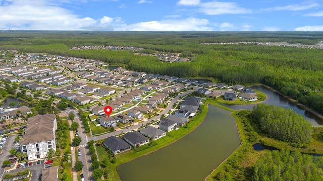 bird's eye view with a residential view, a wooded view, and a water view