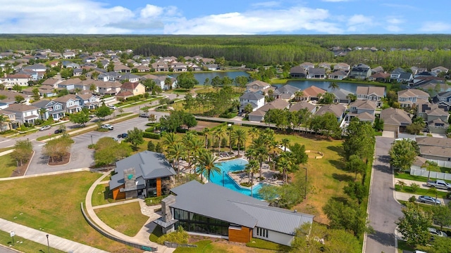 aerial view featuring a view of trees, a residential view, and a water view