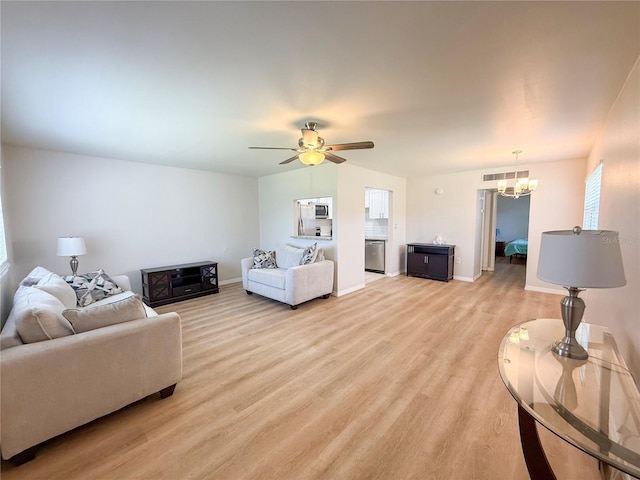 205 Andover Pl N Unit 110, Sun City Center, FL 33573 - living area with a chandelier, light wood-type flooring, a ceiling fan, and baseboards