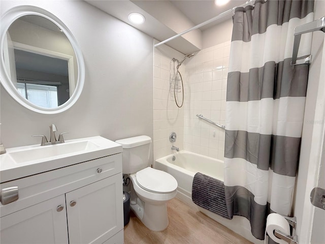 205 Andover Pl N Unit 110, Sun City Center, FL 33573 - full bathroom with wood finished floors, toilet, shower / bathtub combination with curtain, vanity, and recessed lighting