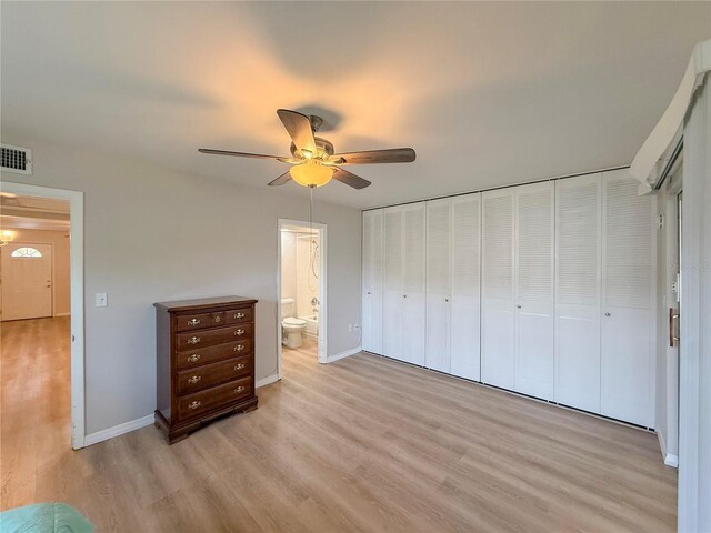 205 Andover Pl N Unit 110, Sun City Center, FL 33573 - unfurnished bedroom featuring light wood-type flooring, baseboards, ensuite bathroom, and ceiling fan