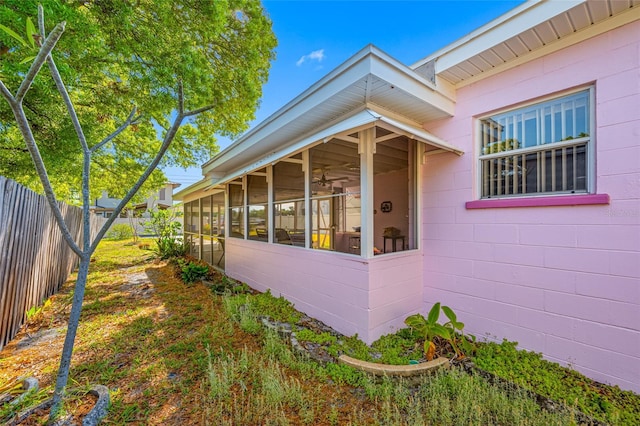 2827 1st St NE, Saint Petersburg, FL 33704 - view of home's exterior with concrete block siding, a fenced backyard, and a sunroom