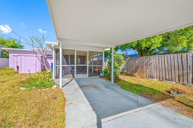 2827 1st St NE, Saint Petersburg, FL 33704 - view of patio featuring a sunroom and fence