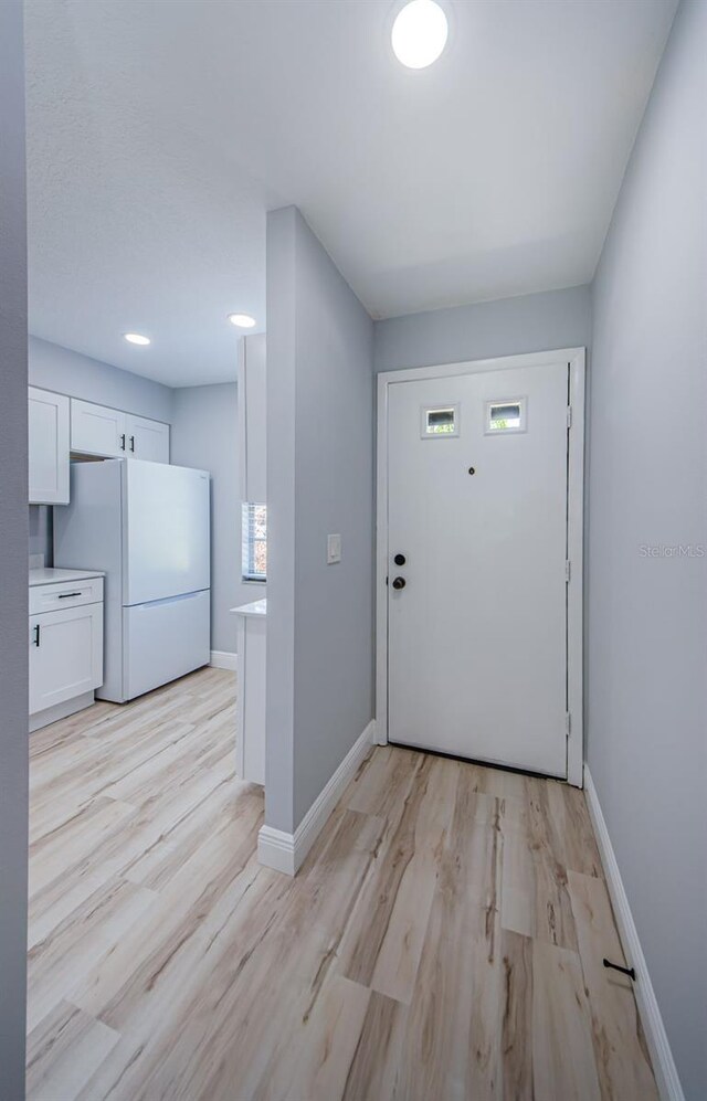 3143 Mission Grove Dr, Palm Harbor, FL 34684 - foyer featuring light wood-style flooring and baseboards