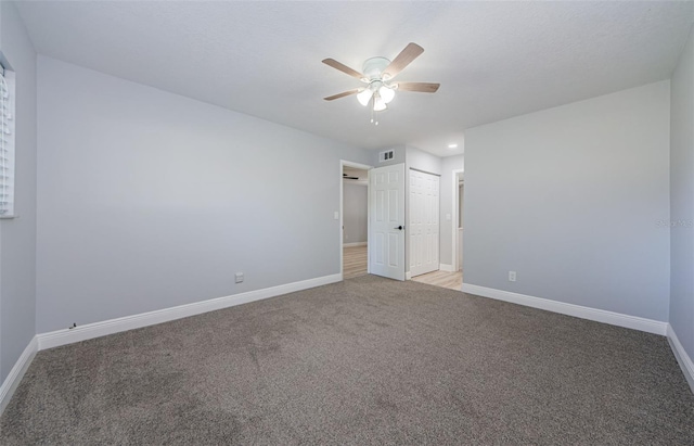 3143 Mission Grove Dr, Palm Harbor, FL 34684 - unfurnished bedroom featuring carpet floors, baseboards, and visible vents
