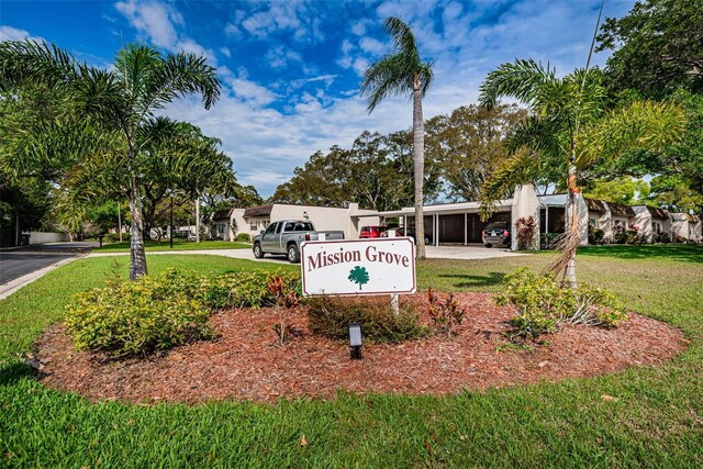 3143 Mission Grove Dr, Palm Harbor, FL 34684 - community / neighborhood sign featuring a carport, driveway, and a lawn