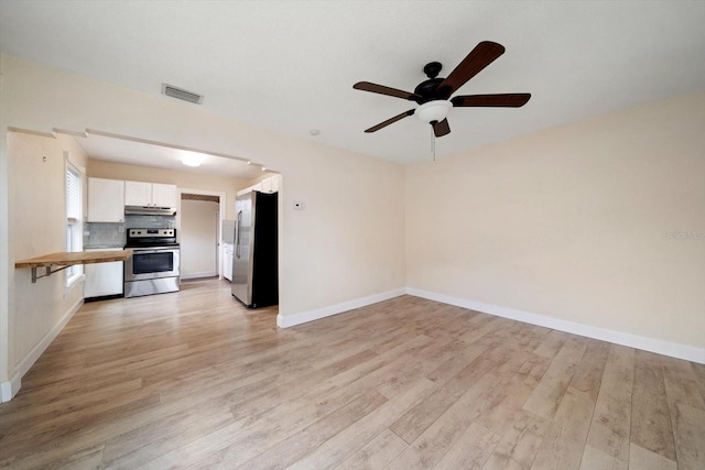2585 9th Ave N, Saint Petersburg, FL 33713 - unfurnished living room with ceiling fan, light wood-style flooring, and baseboards