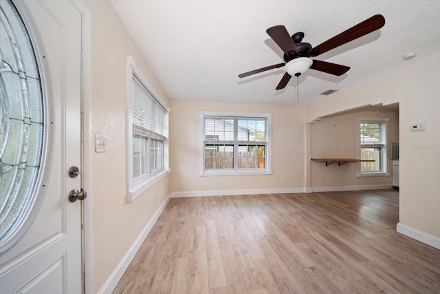 2585 9th Ave N, Saint Petersburg, FL 33713 - entrance foyer with wood finished floors, plenty of natural light, baseboards, and ceiling fan