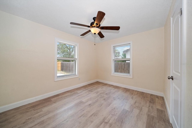 2585 9th Ave N, Saint Petersburg, FL 33713 - empty room featuring light wood finished floors, healthy amount of natural light, and baseboards