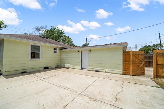 2585 9th Ave N, Saint Petersburg, FL 33713 - rear view of property featuring a patio, fence, crawl space, roof with shingles, and a gate